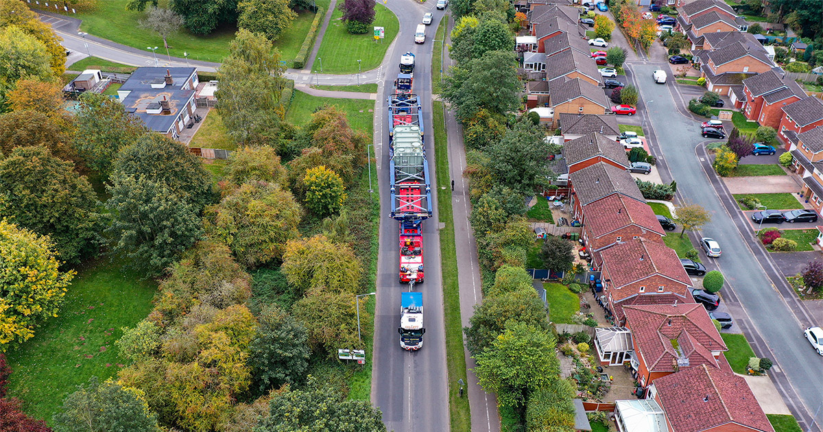 Greiner Bridge Deployed 02 Side view of Collett’s 350Te Greiner modular girder bridge in 30-axle configuration deployed for GE heavy transformer transport on a bridge