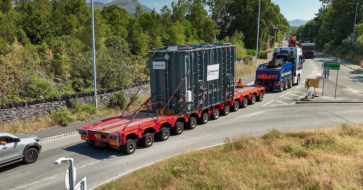 Beach-Landing-O3 Collett transporting the shunt reactor through a road junction on a 12-row modular drawbar trailer.